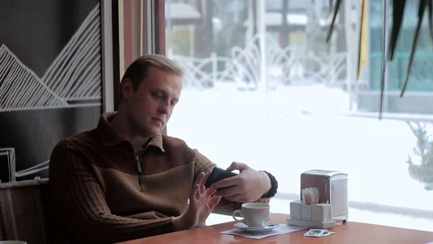 Man using smartphone in a cafe. Stock Footage 70692739
