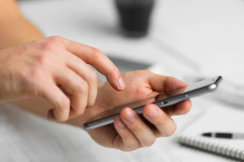 Man using smartphone in cafe a touch screen smart phone hands close up, vinta 스톡 사진