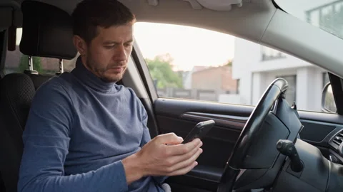Man using smartphone in car before driving Stock Footage 341845937
