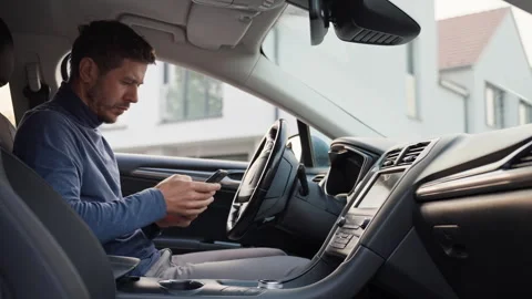 Man using smartphone in car Stock Footage 340490038