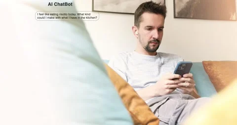 Man using smartphone to chat with AI assistant at home, asking for a risott.. Stock Footage 311119787