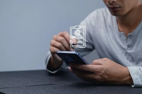 Man Using Smartphone for Checklist Management and Task Organization Stock Photos