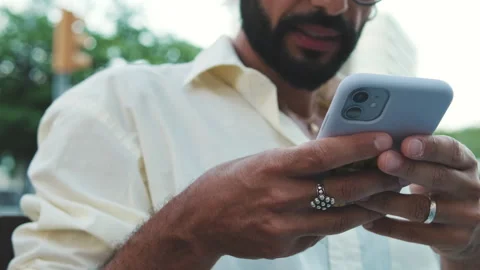 Man Using Smartphone in the City. Focus on the hands Stock Footage 303779205
