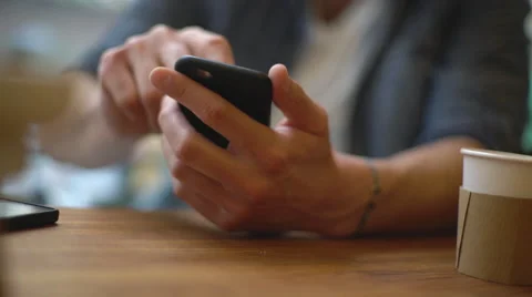 Man using smartphone in coffee shop Stock Footage 63301260