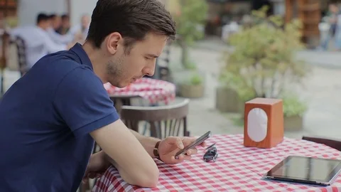Man using smartphone in Coffee Shop. Stock Footage 76835176