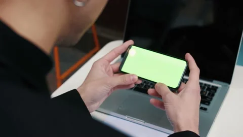Man using smartphone in Coffee Shop. Smartphone with Green Screen outside urban Stock Footage 143875402