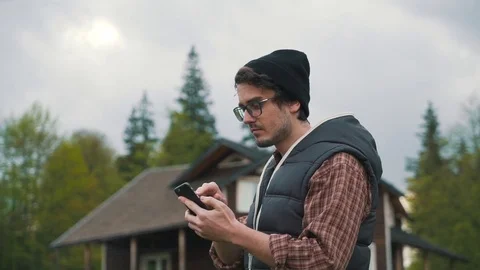 Man using smartphone in countryside Stock Footage 76248034