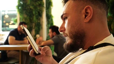 Man using smartphone in cozy café Stock Footage 317849099