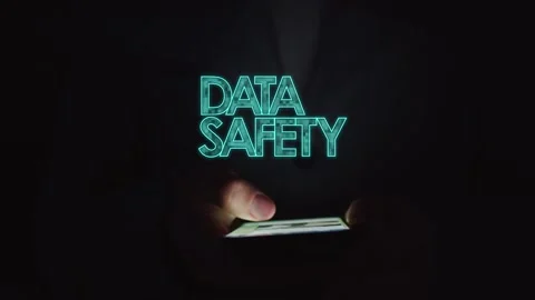 A man is using a smartphone in the dark and digital database security symbols Stock Footage 287562415