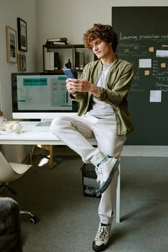 Man Using Smartphone by Desk in Creative Modern Office 스톡 사진