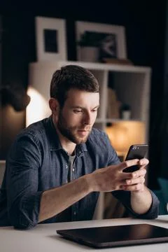 Man using smartphone during free time at home Stock Photos