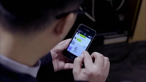 The man is using a smartphone to edit a text message Stock Footage 265537566