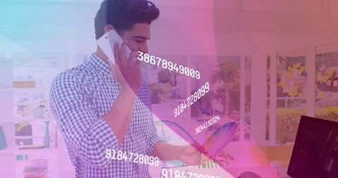 Man using smartphone examining color wheel in tech office, interacting with Stock Footage 326881583
