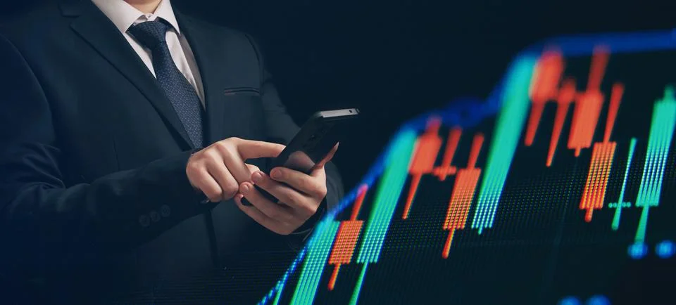 Man using smartphone with graphs analysis candle line and foreign currency ra Stock Photos