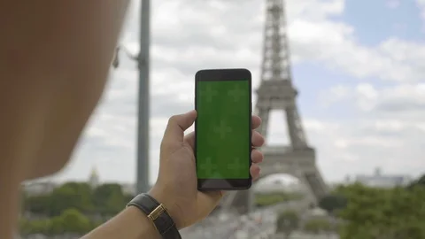 Man using smartphone with Green Screen at Eiffel Tower, Swiping and Scrolling on Stock-Footage 111926471