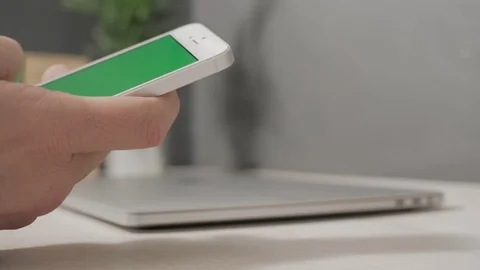 Man using smartphone with a green screen Stock Footage 120594837