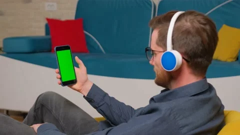 The man is using a smartphone with a green screen model. Stock Footage 140714760