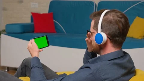 Man is using a smartphone with a green screen model. Stock Footage 141186711