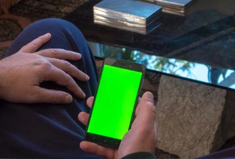 Man using a smartphone with green screen Stock Photos
