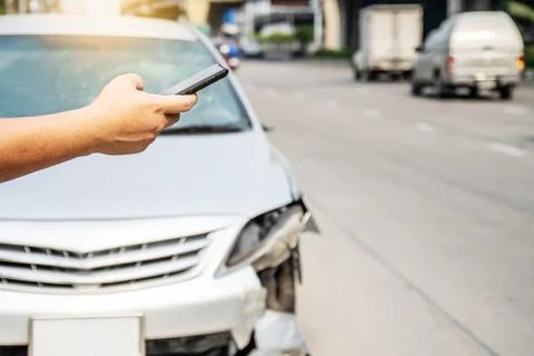 Man using smartphone help calling car mechanic at roadside after traffic ac.. Stock Photos