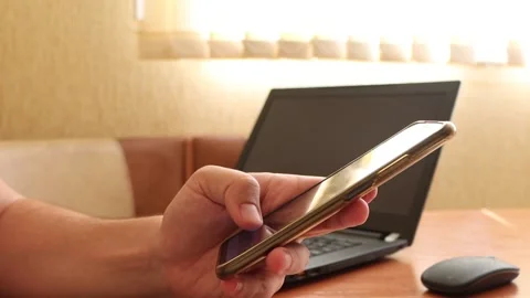 Man using smartphone in a home office. Stock Footage 260006128