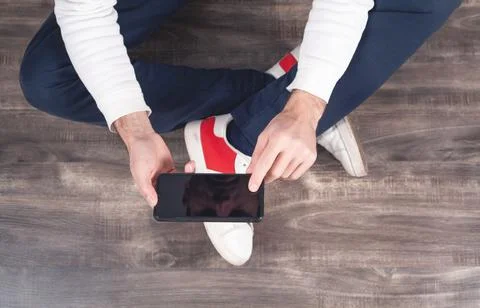 Man using smartphone at home. Stock Photos
