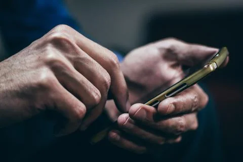 Man using a smartphone indoors. 스톡 사진