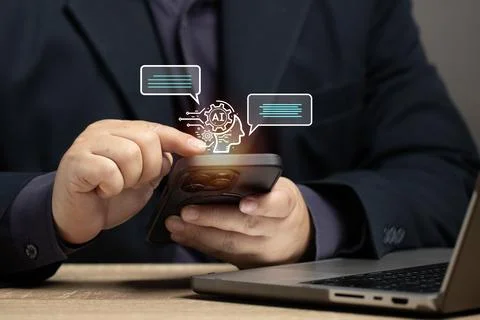 Man using smartphone to interact communication with AI program. Concept of .. Stock Photos