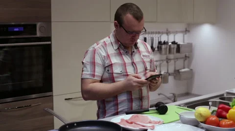 Man using smartphone in the kitchen Stock Footage 58086032