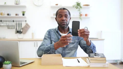Man Using Smartphone at Kitchen Table Stock Footage 347984497