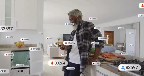 Man using smartphone leaning on kitchen counter, showing floating social media Stock Footage 329124131
