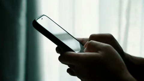 Man using smartphone in the living room at home, Close-up of hand typing message Stock Footage 140664246