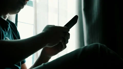 Man using smartphone in the living room at home for online dating or shopping Stock Footage 140947023