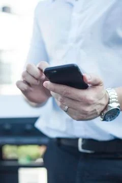 Man using smartphone, mid section Stock Photos
