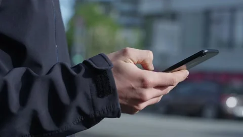 Man using smartphone next to busy street in city Stock Footage 132708160