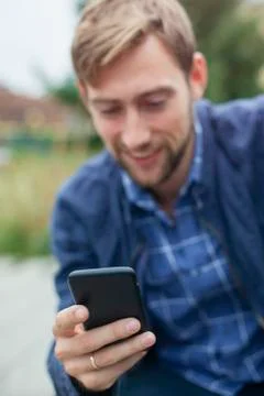 Man using smartphone outdoors 스톡 사진