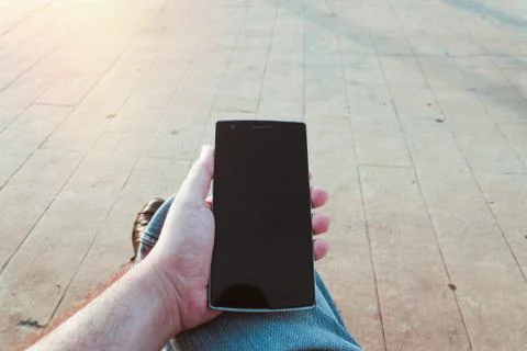 Man using the smartphone outdoors Stock Photos