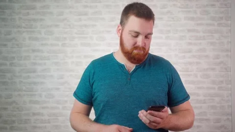 Man Using Smartphone Over Isolated White Background. Person Holding Phone Device Stock Footage 244410528