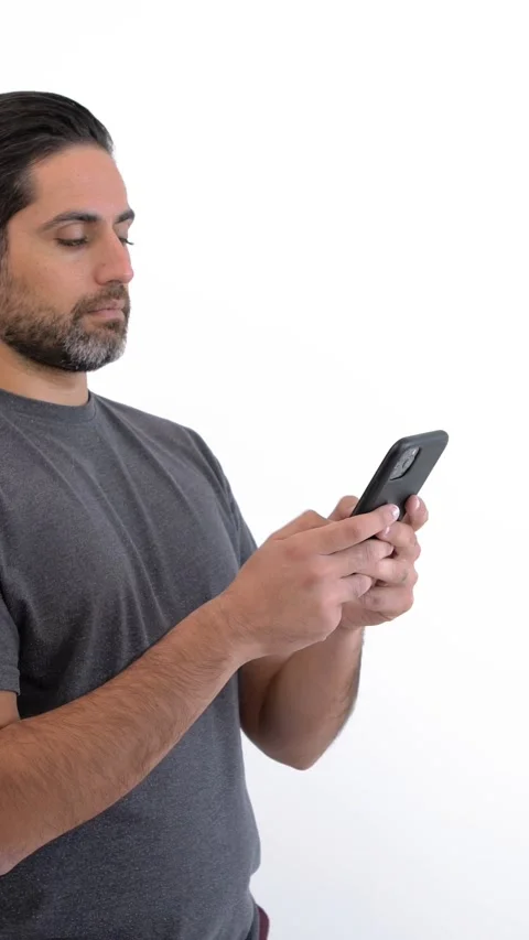Man using smartphone over isolated white background. Person holding phone device Stock Footage 328020692