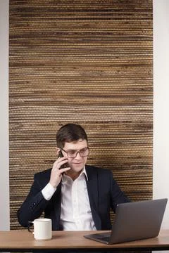 A man using a smartphone to pay in an online store on a laptop uses a QR code Stock Photos