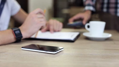 Man using a smartphone is paying in a restaurant Stock Footage 90952027
