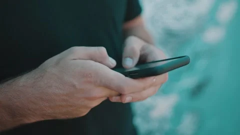 Man using smartphone, Person texting on mobile device Stock Footage 339589976
