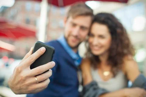 Man using smartphone to photgraph himself with his wife Stock Photos