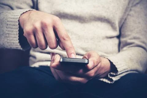 Man using smartphone Photos