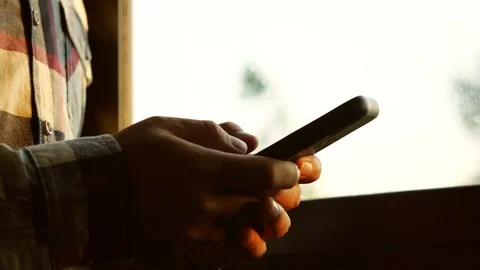 Man using smartphone in the room with window background. Stock-Footage 126018015