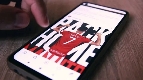 Man Using Smartphone With To Scroll Instagram Profile Of Cristiano Ronaldo. 스톡 동영상 163960638