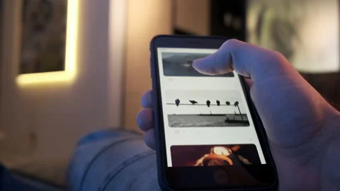 Man using smartphone scrolling through social network feed, doing swiping Stock Footage 153527107