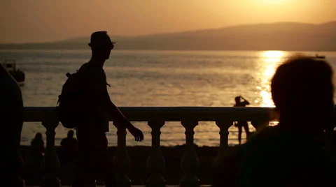 Man using smartphone by the sea. tourist walks along the promenade. photograph Stock Footage 65431411