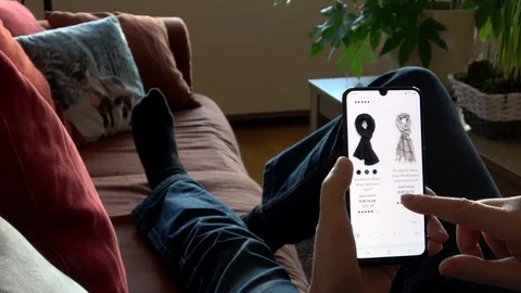 A Man Using Smartphone Shopping Online For Clothes Stock Footage 123122539