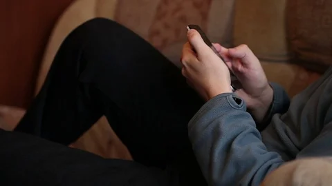 Man using a smartphone. sitting on the couch. Close-up Stock-Footage 72560955